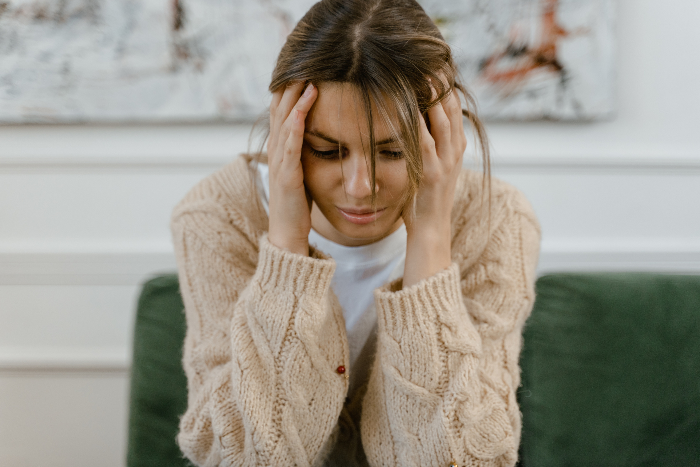 A Sad Woman Sitting on a Sofa